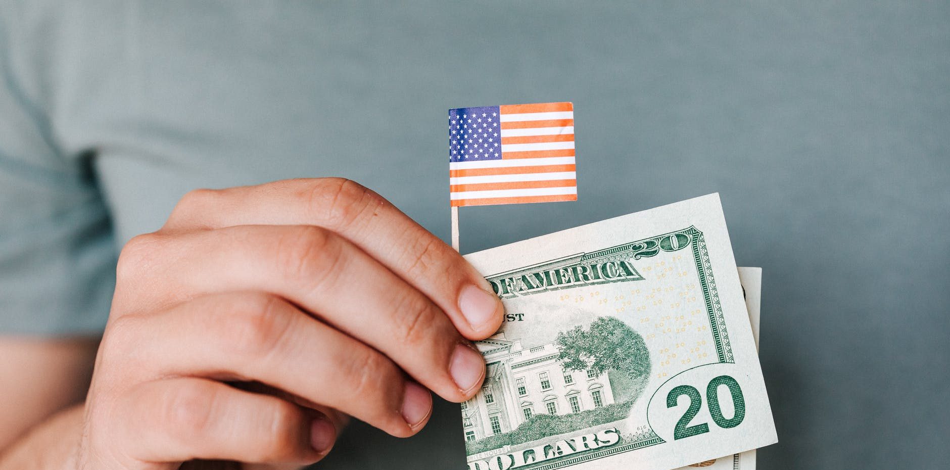 Holding cash and a tiny U.S. flag